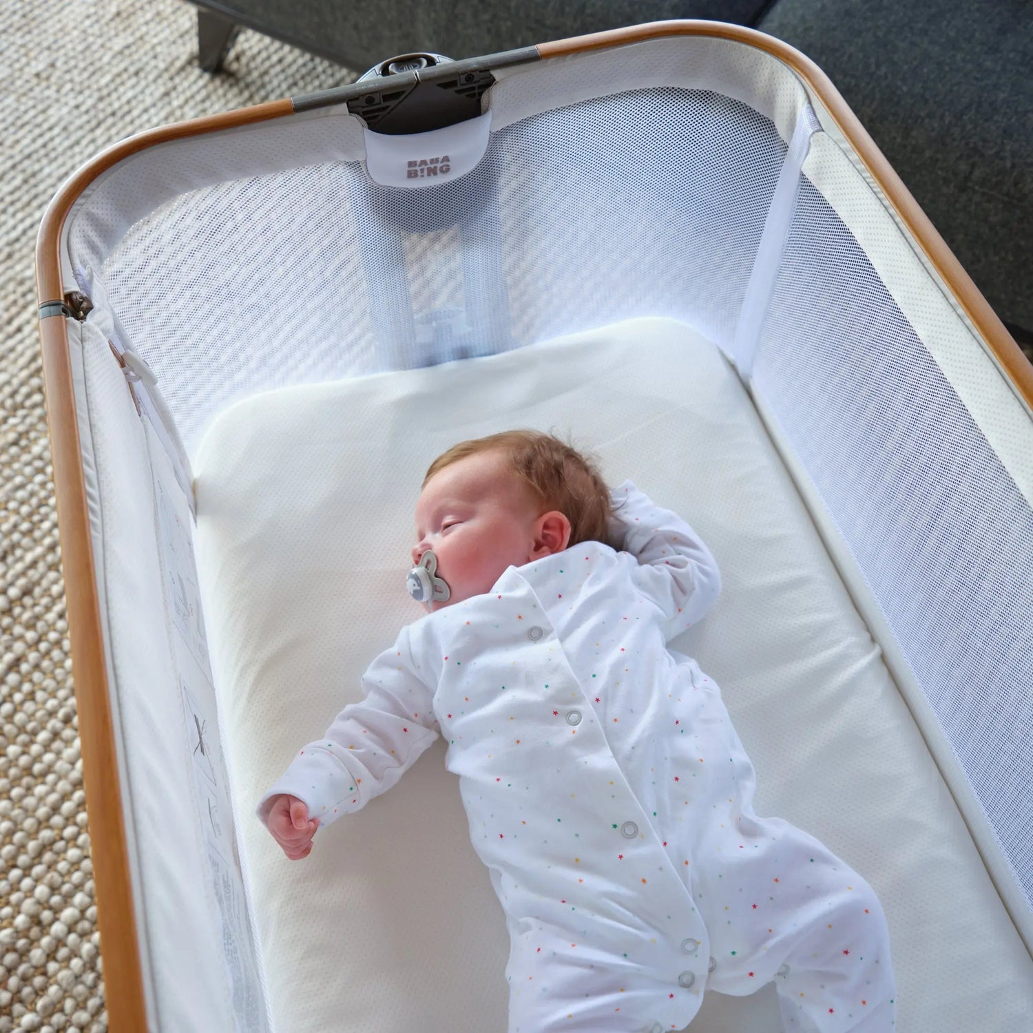 baby sleeping in travel cot