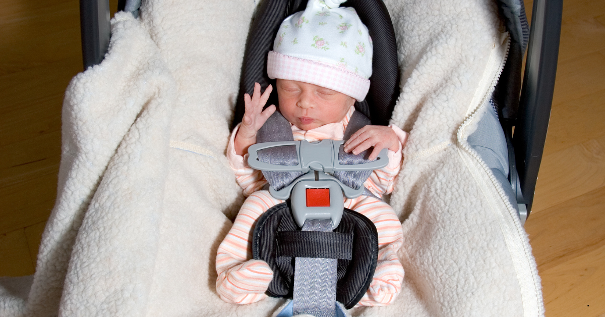 baby smiling sitting in car seat