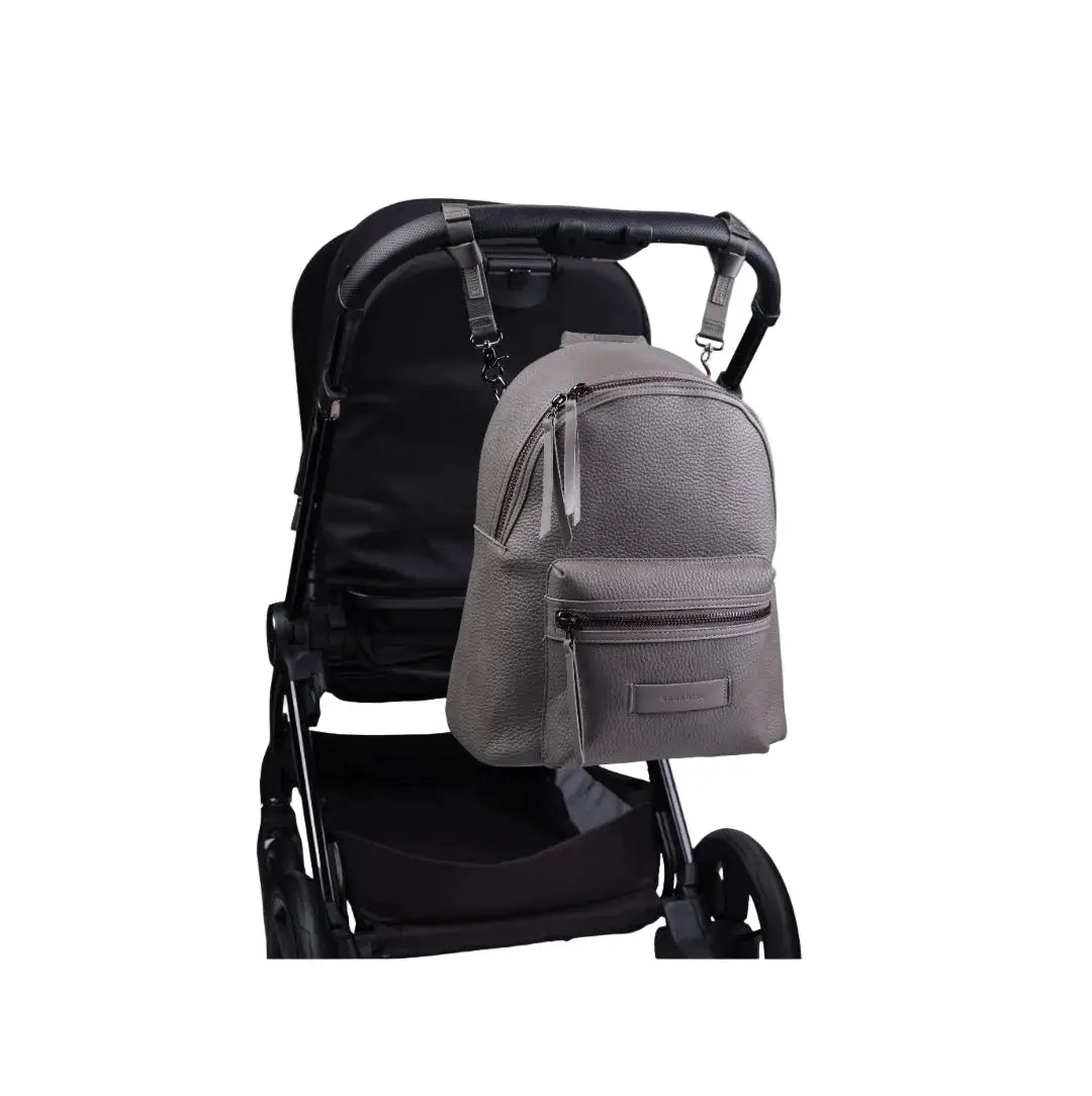 luca baby changing bag in grey colour on back of travel system on white background