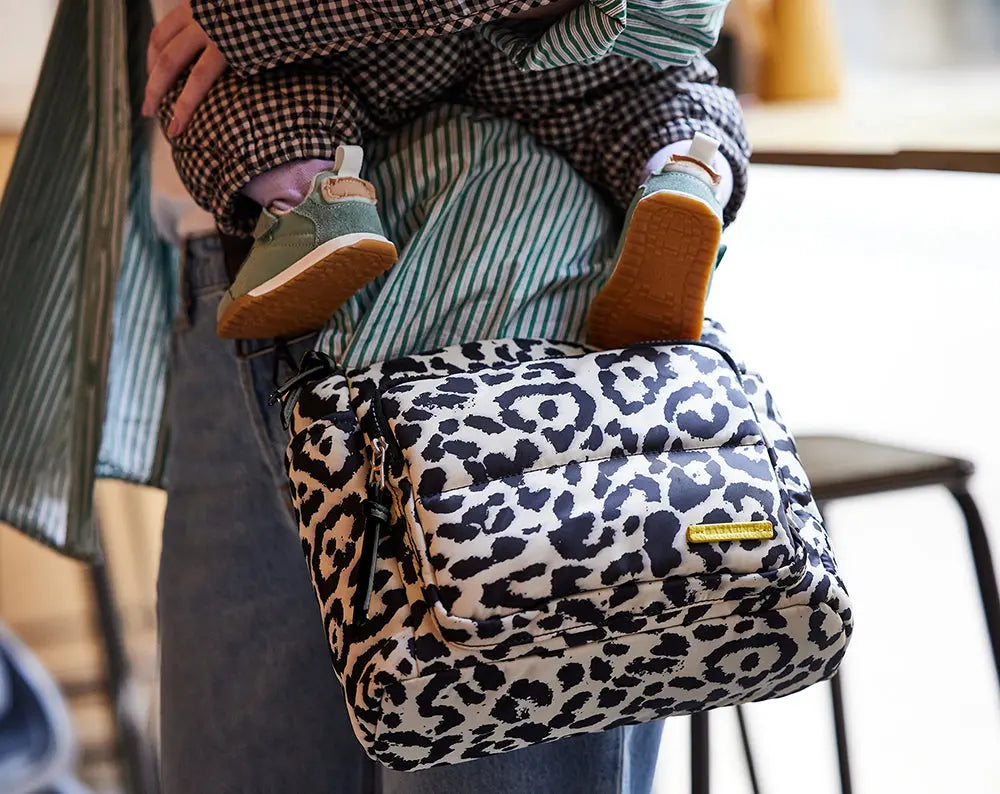 lifestyle image of the joey leopard print baby changing bag