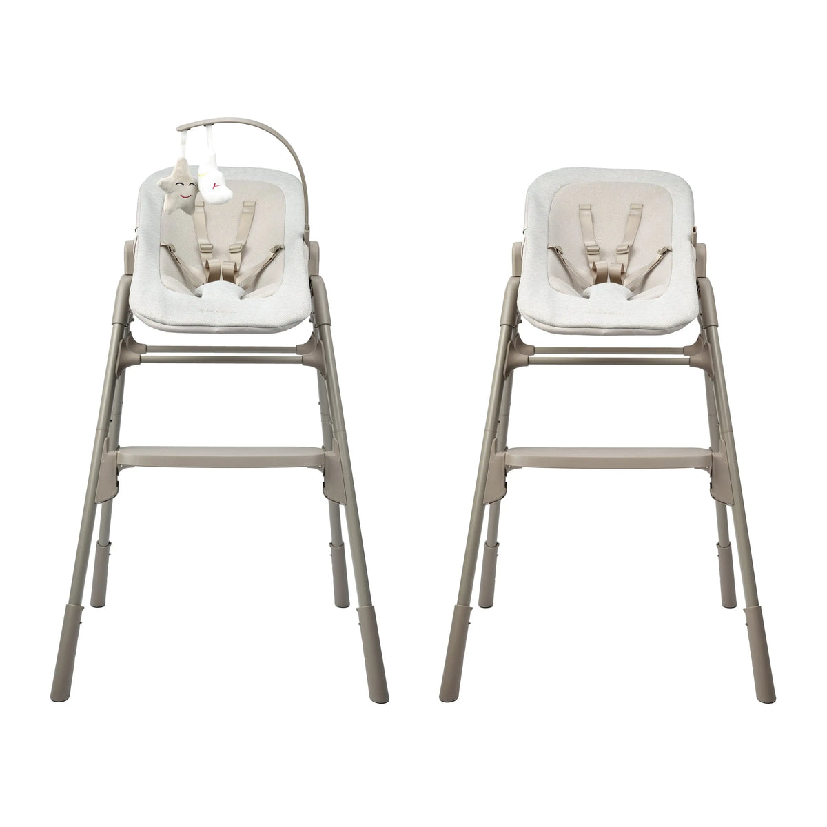 Two beige baby high chairs with cream padded seats and harnesses, shown side by side on a plain white background. The left chair includes a curved hanging baby toy.