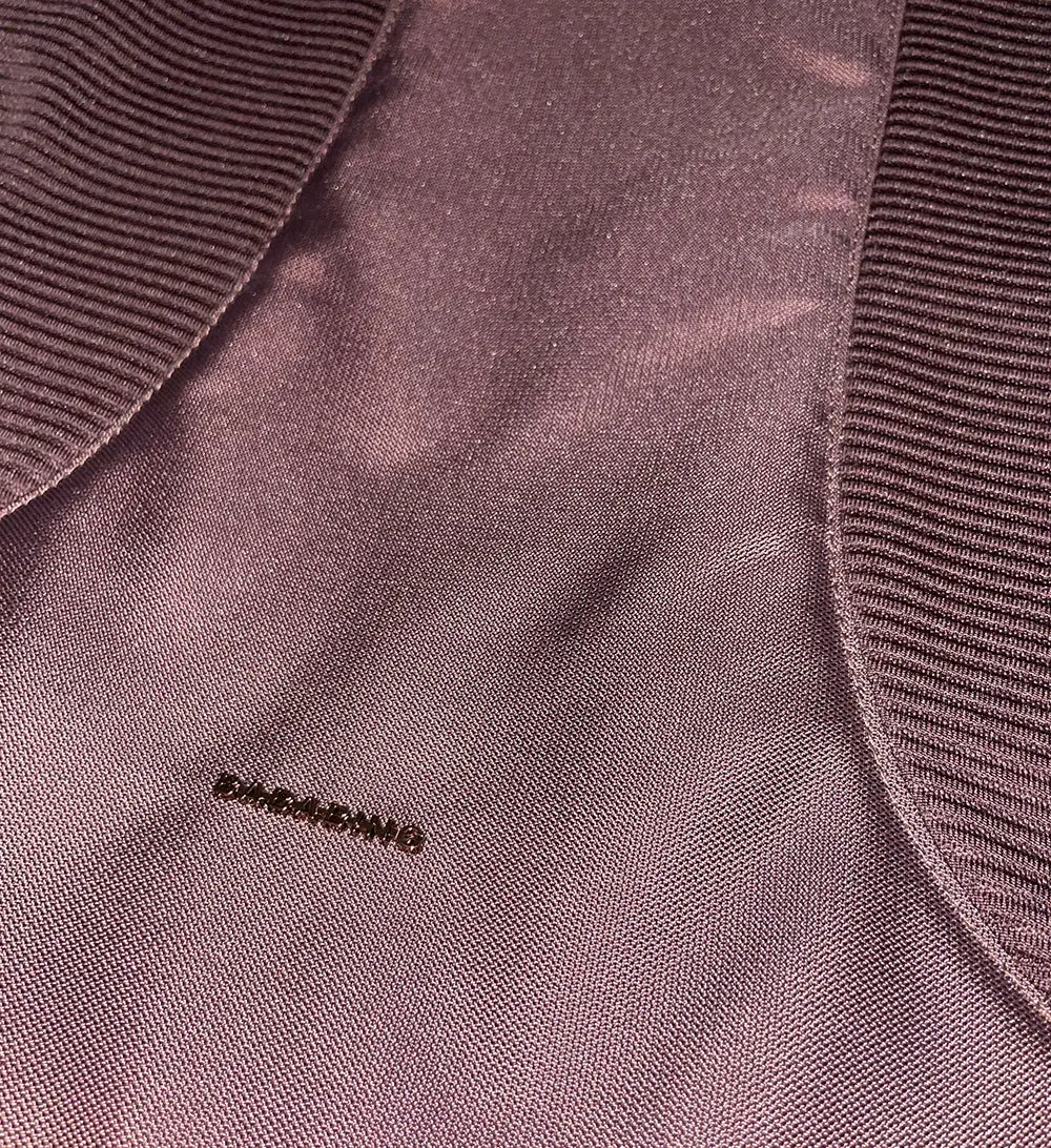close up of burgundy travel system carry cot apron showin branding and detail.