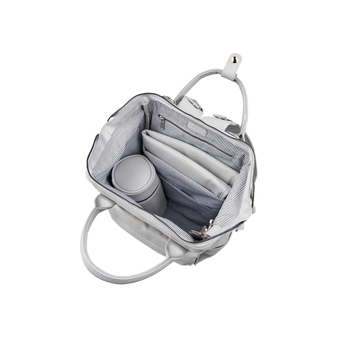 a view of a grey baby changing bag with the main section open on a white background