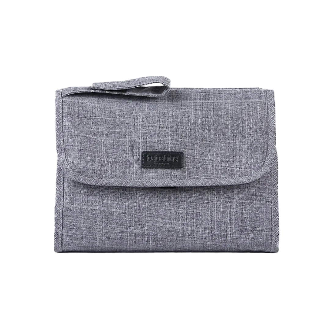 A folded gray changing mat with a velcro closure and a label showing the brand 'Bababing'.